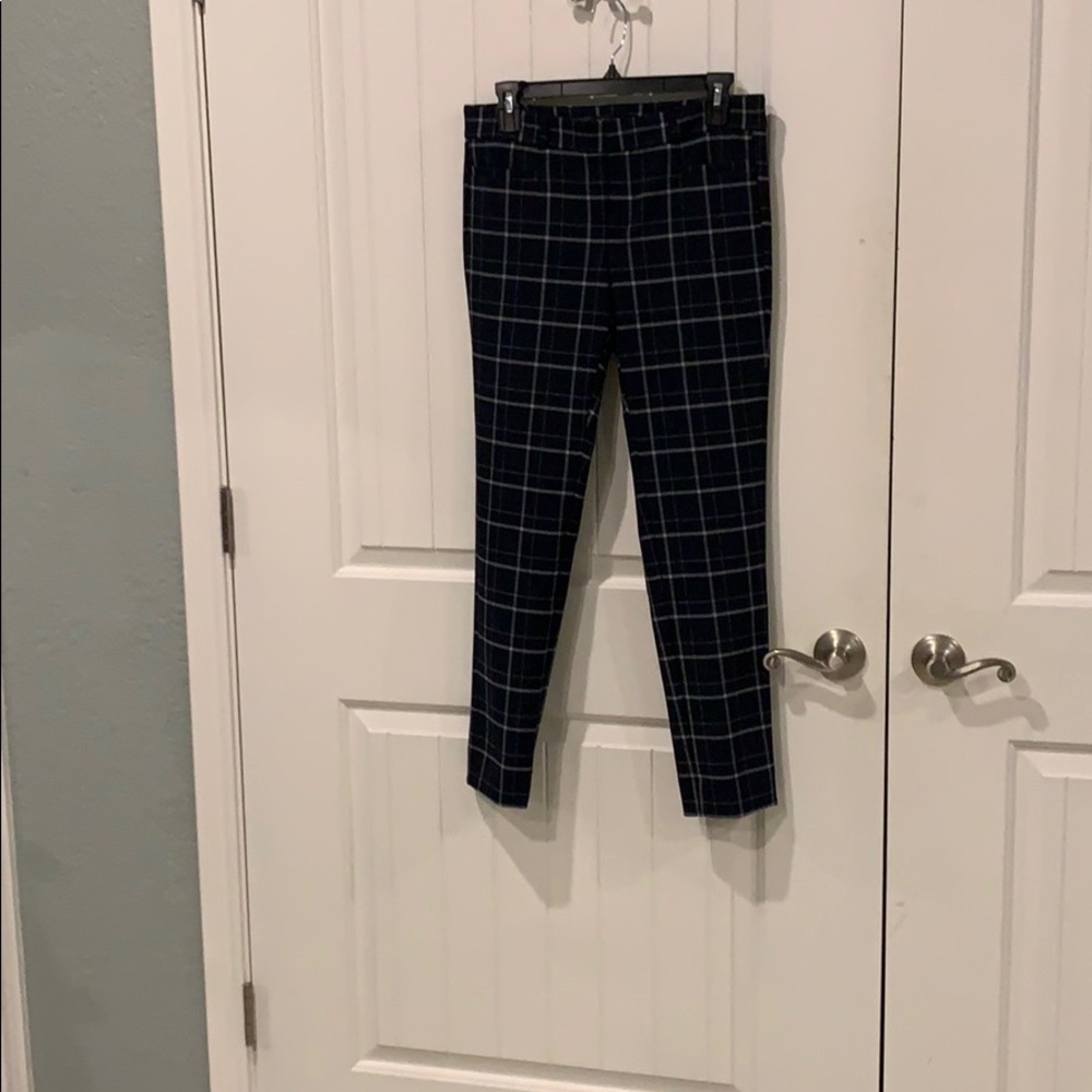 Navy and white slacks with horizontal pockets.